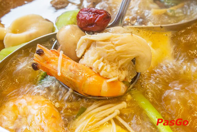 Bàn ăn với nồi lẩu cá nhân và các món nhúng tươi ngon trên băng chuyền tại Kichi Kichi Vincom Thủ Đức