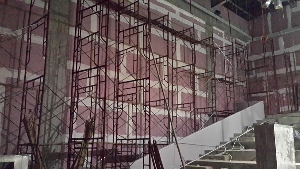 Công nhân đang cố định tấm thạch cao vào khung xương vách tại dự án rạp CGV Vincom Đà Nẵng.