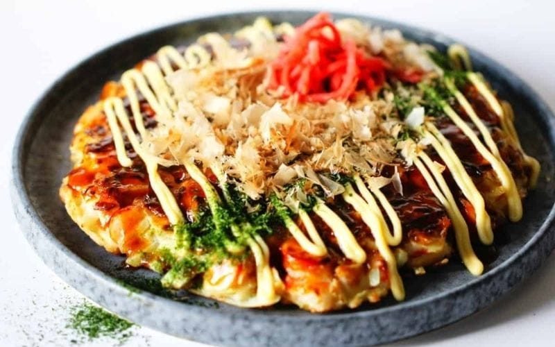 Kansai: Ingredients mixed, pan-fried, topped with sauce